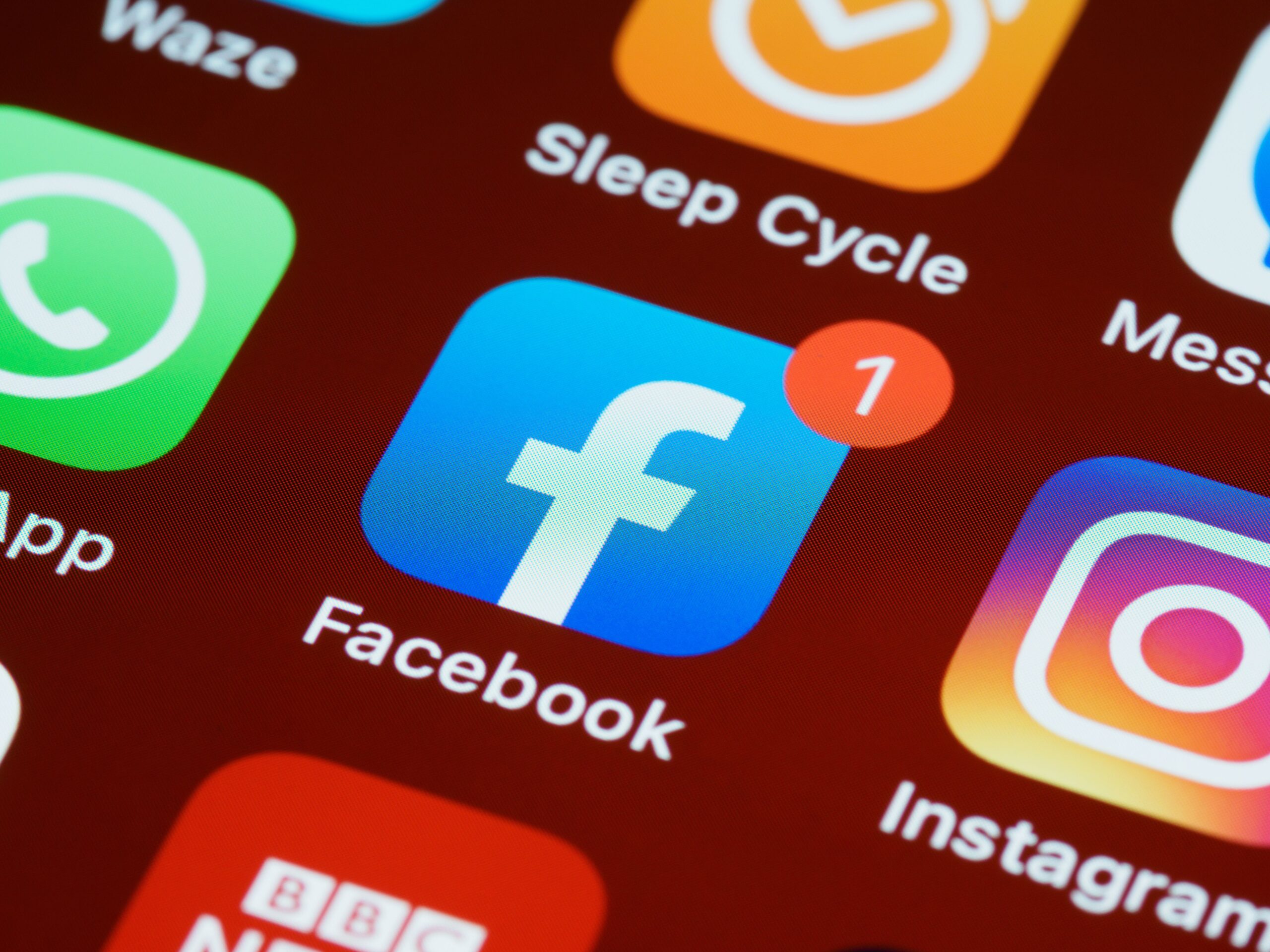 About A detailed close-up of social media app icons on a smartphone screen.